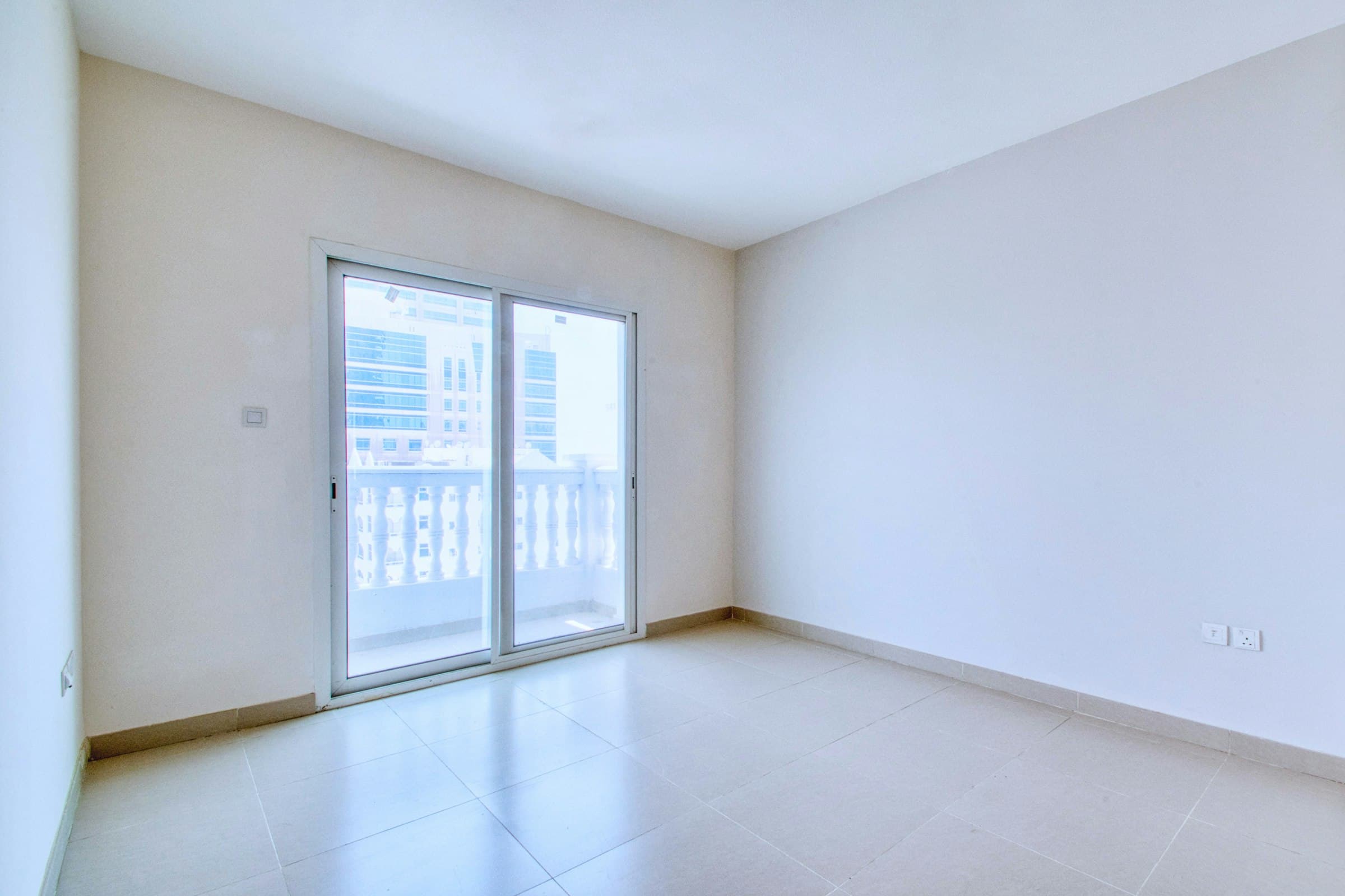 Empty apartment room with open balcony door, suitable for a rental vacancy article cover